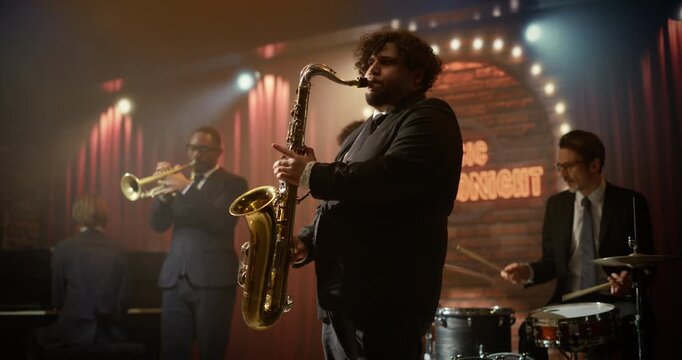 Male Saxophonist Fronts a Live Jazz Band in a Bar Concert, Playing a Rich Song on Stage Music Event. Audience Enjoys the Music Event and Follows His Dynamic Solo Performance