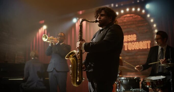 Male Saxophonist Performs Live Jazz with a Band. Concert in a Bar, Playing a Driving Song on Stage as Trumpet, Piano, Bass, and Drums Lift the Music Event for the Audience.