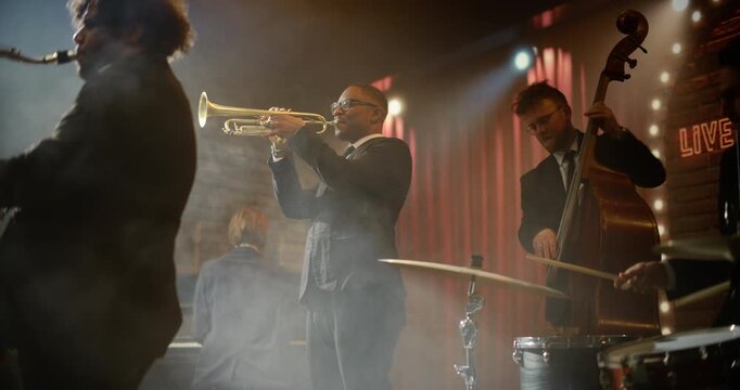 Black Male Trumpeter Commands a Live Jazz Band on a Smoky Bar Stage, Playing a Vibrant Concert Song as Sax, Piano, Bass, and Drums Drive the Music Event and Audience Energy All Night.