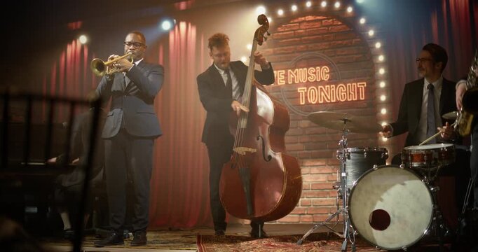 Live Jazz Band Musicians Perform on a Bar Concert Stage as a Black Male Trumpeter Leads the Song, Joined by a Male Bassist, Drummer, and Pianist, Energizing the Audience at a Night Event.