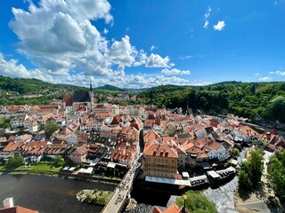 Aerial panoramic view of the historic town of Cesky Krumlov with red roofs and river © Watata_Photography