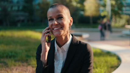 Fototapeta premium Smiling Business Woman On Phone In Park