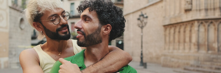 Close up, homosexual couple stands hugging on street of old city. Panoramic © Andrii Nekrasov