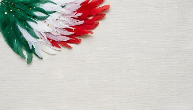 Decorative arrangement of green white and red feathers with gold sequins on a textured neutral background
