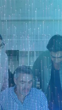 Vertical video: Team leaning in, lead guiding review of papers for business, blue streak overlaying
