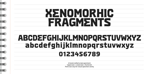 Obraz premium Bold geometric block font alphabet with numbers on lined spiral notebook paper background