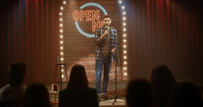 Male Standup Comedian Performs a Funny Live Open Mic Set in a Comedy Club, Telling Jokes, Pausing for Laughs, and Engaging the Crowd on Stage With Confident Delivery and Sharp Timing.