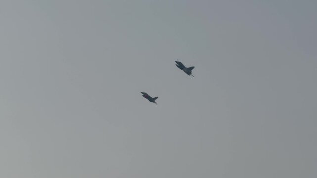 Two Mirage 2000‑9 multirole jets fly in tight formation, showcasing UAE Air Force precision and power.