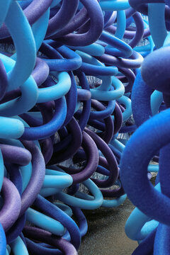 Porous thermal insulation tubes. Blue, violet, purple colored circular cross-section sealing tapes made of closed-cell polyethylene foam.