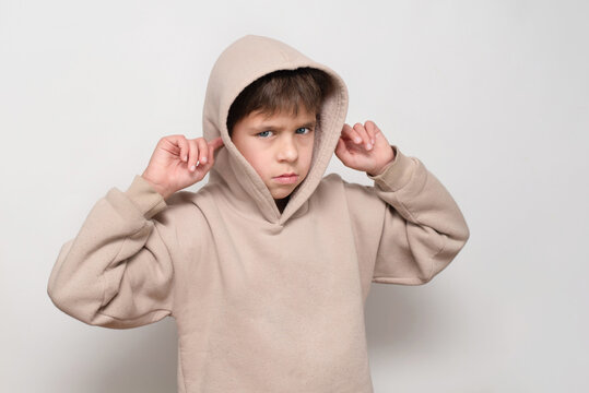 A young boy has a bad temper, he got into argument with his friends and now doesn't want to listen to his parents and covers his ears, showing disrespect and disobedience