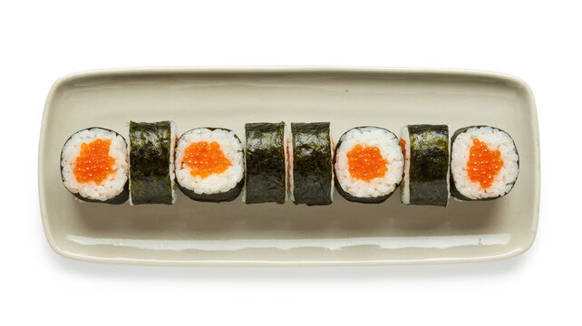 Seven pieces of sushi rolls with orange fish roe on a long rectangular ceramic plate view