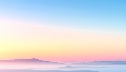Fototapeta premium 淡い朝焼け空と霧に包まれた山並みの幻想的なパステル風景