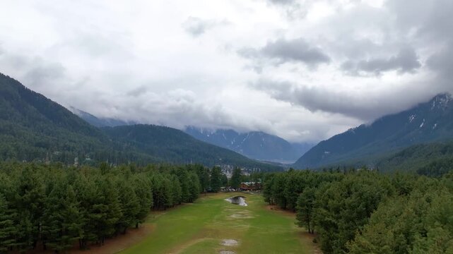 Epic backward aerial reveal of Pahalgam golf course and Lidder valley.