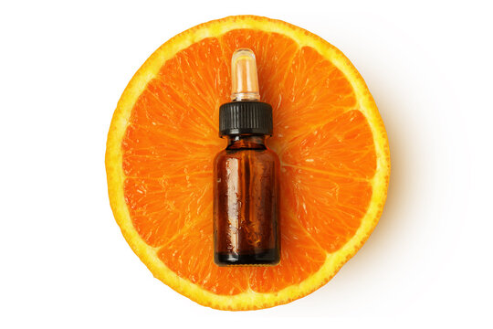 Top-view of orange fruit with essential oil glass bottle- Concept of orange sssential oil abd Vitamin C