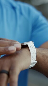 Smart watch, fitness and hands of man in city for tracking exercise, workout app and health info. Sports, runner and person with tech to check time, wellness stats and training progress in town