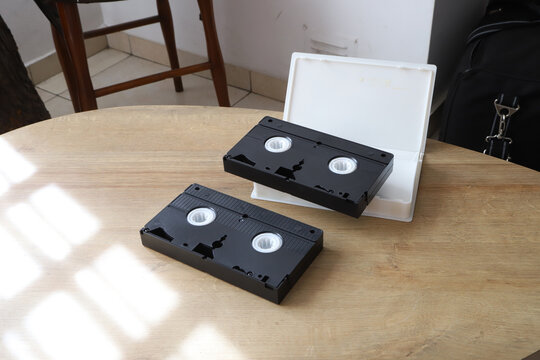 VHS tapes on a wooden table. Vintage cassettes with copy space. Retro