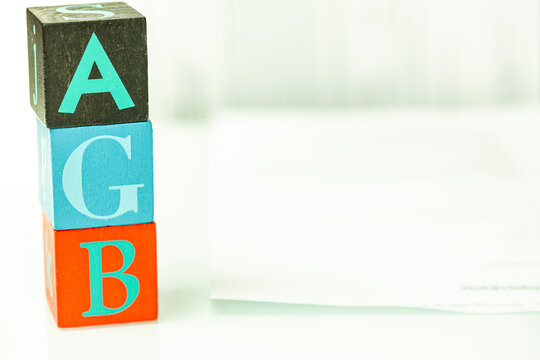 Colorful wooden alphabet blocks spelling out letters form a vertical stack