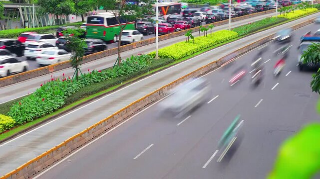 Timelapse of traffic congestion conditions on Sudirman Street during rush hour with Transjakarta buses passing in their own lane.
