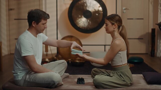 Meditation instructor handing associative cards to student