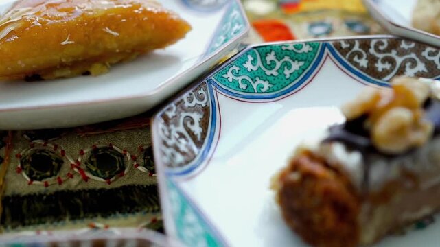 Close-up of various oriental appetizers and sweets served on decorative ceramic dishes