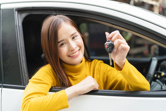 transportation rental automotive business concept. Close up hands of rental auto agent giving car remote key to client to travel sightseeing.