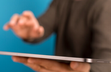 Close-up of a hand interacting with tablet, conveying modern technology and digital connection. © vegefox.com