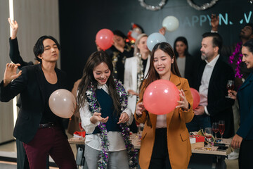 Fototapeta premium Party balloon celebration group young adult office event festive indoor social gathering happy people holding balloon cheerful atmosphere decoration party celebration