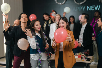 Fototapeta premium Party celebration group of people holding balloon at indoor event with joyful smile and festive decoration
