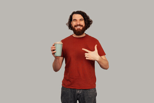 White Man Holding Reusable Cup Pointing, Promoting Sustainable Habit, Ecofriendly Tumbler, Commuter Morning