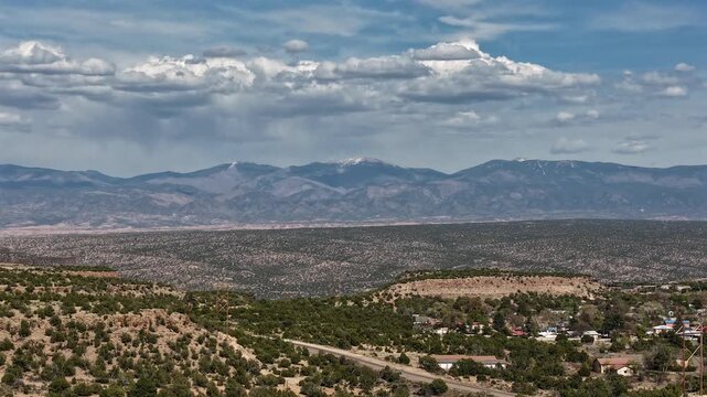 This cinematic drone timelapse features dramatic weather patterns as stormy clouds roll over the Santa Fe Baldy mountain peak. Ideal for atmospheric storytelling and high-altitude b-roll.