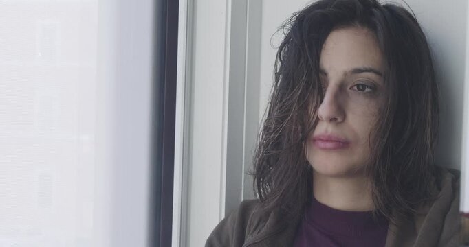 Dark-haired woman cries intensely after a breakup. The scene expresses heartbreak, emotional pain, and deep sadness following the end of a relationship.