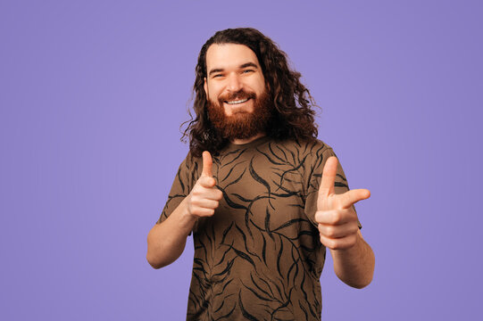 Caucasian Man Playful Pointing Finger Guns, Charismatic Presenter Vibe With Confident Grin, Purple Studio