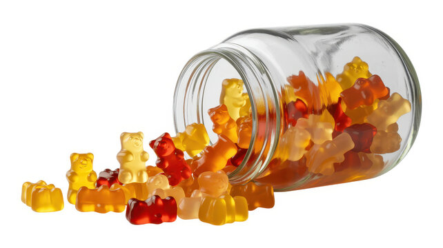 Colorful gummy bear candies spilling out of a clear glass jar on a white background