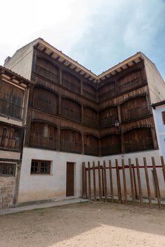 Traditional house in the historic Plaza del Coso, Pe&ntilde;afiel, Spain. This iconic building features unique wooden balconies, rustic shutters, and typical Castilian architecture of the famous town square.