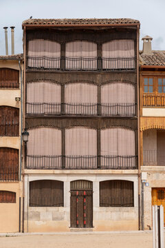 Traditional house in the historic Plaza del Coso, Pe&ntilde;afiel, Spain. This iconic building features unique wooden balconies, rustic shutters, and typical Castilian architecture of the famous town square.