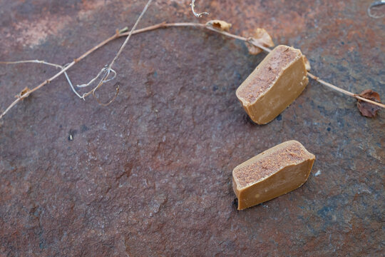 Masala praline on a rusty stone. Minimal. Moodboard. Copy space. Soft depth of field.