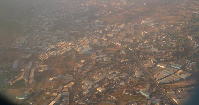 Mumbai, India. Nagzari, Maharashtra. Staorage buildings. Aerial View From Airplane Window On View of the Mumbai suburb district. Evening morning sunset sunrise light. Video From Plane Window.
