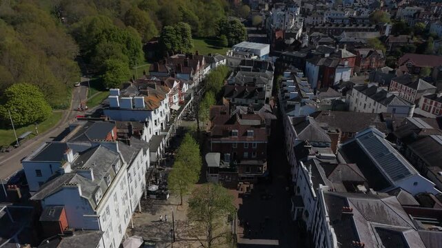 Historic Pantiles at Royal Tunbridge Wells in springtime. Old street with restaurants, shops and a hotel with outdoor sitting. Aerial view flying above quiet town square towards High street.