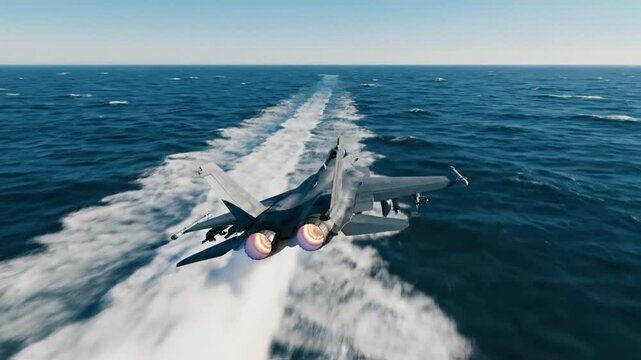 Jet fighter catapult launch from aircraft carrier over water