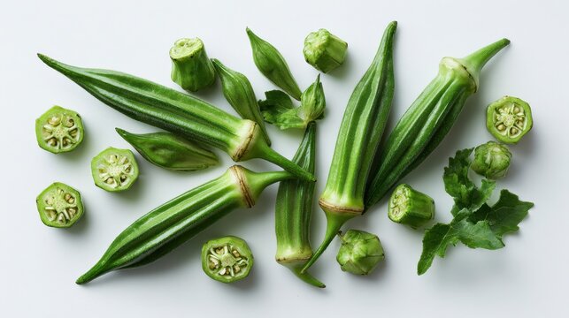 Top-down shot of okra pods with green roselle calyces on a white backdrop