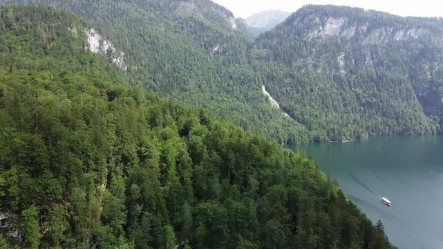 High Angle Aerial View of Dep Green Forest Canopy andAlpine Tour Boat