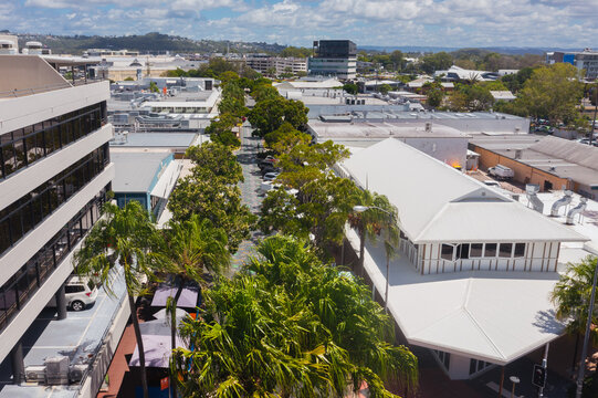 aerial view of tree lined main street in a small coastal town