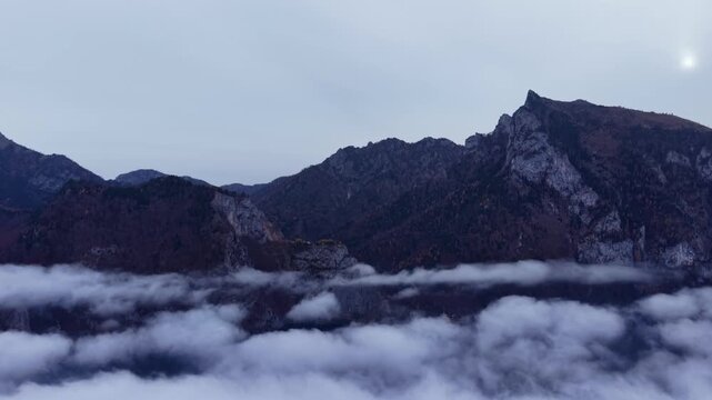 Moody Aerial View of Dark Jgged Mountain Peaks Above olling Fog Sea
