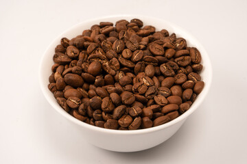 Fototapeta premium Coffee beans on a white background. Top view. Coffee beans texture.