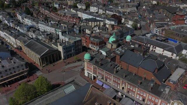 Royal Tunbridge Wells of town center with historic buildings. People walking on the streets. Aerial view in circular motion. Quiet sunny day in Kent, UK.