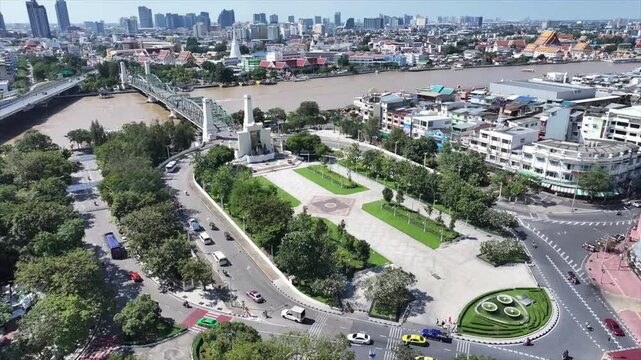 Memorial Bridge or Phra Phuttha Yodfa Bridge crossing river with steel structure and moving vehicles.