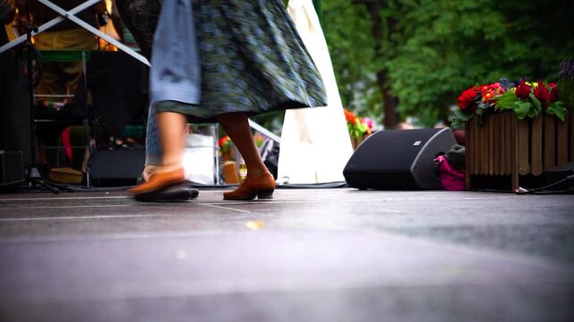 Bayerisches Tanzpaar in Dirndl und Lederhose tanzt traditionellen Volkstanz auf B&uuml;hne