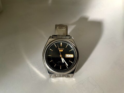 Seiko 5 automatic watch with black dial and golden hour markers, a classic vintage timepiece for luxury, precision, and timeless style.