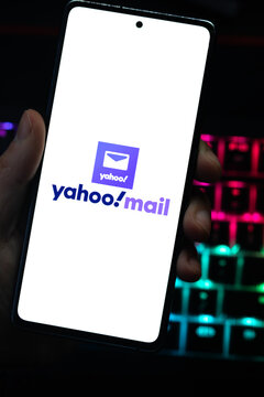 Punta Arenas, Chile &ndash; April 30, 2026: A person holding a smartphone with the Yahoo Mail logo displayed on a white screen, set against a dark background with a glowing RGB mechanical keyboard