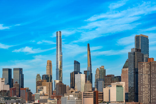 A panoramic view across the Hudson River captures the exceptionally tall and slender residential skyscrapers of a well known Billionaires Row in Midtown Manhattan, New York City.